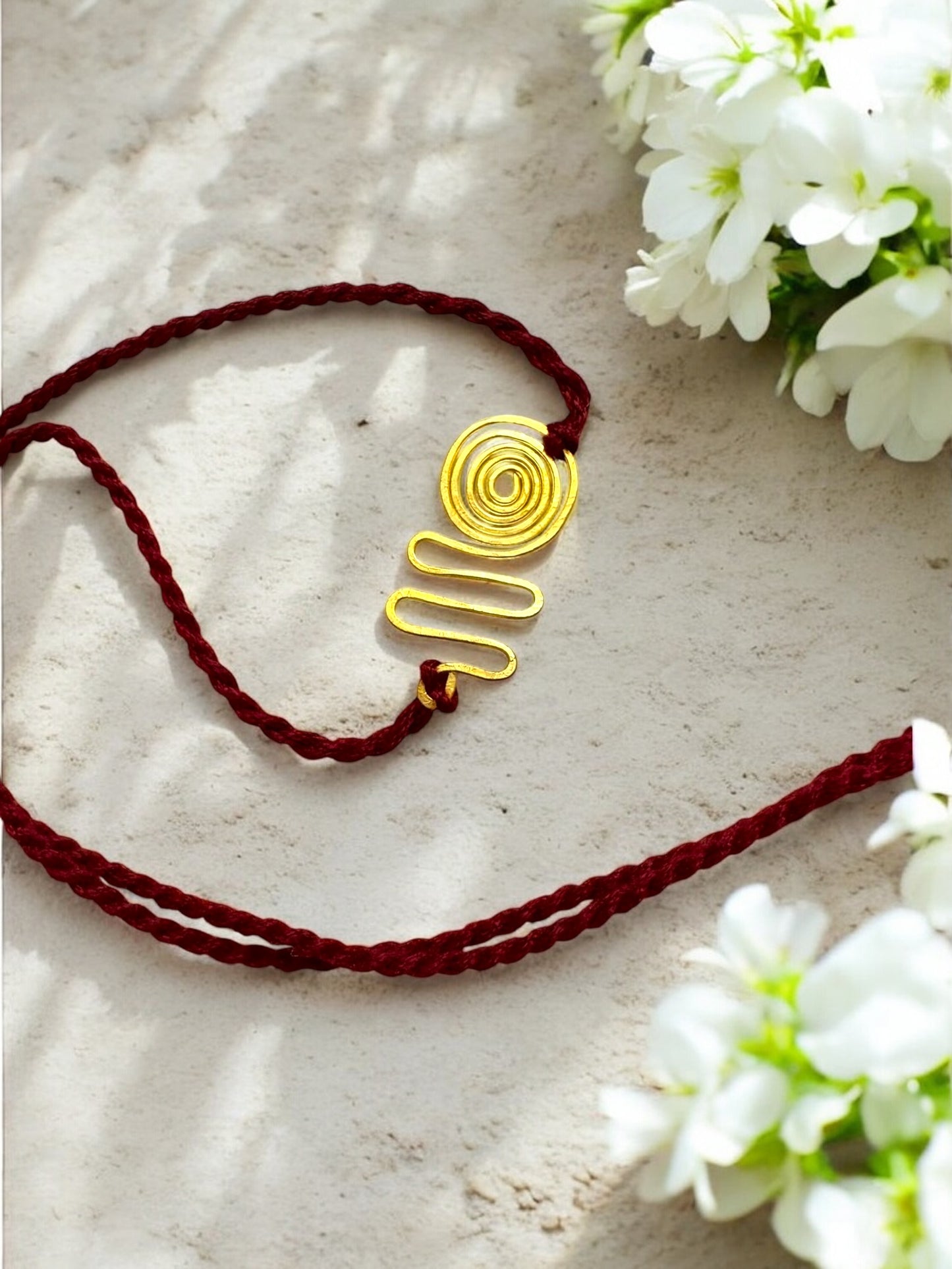 Spiral Wave Forever Brass Rakhi- Maroon