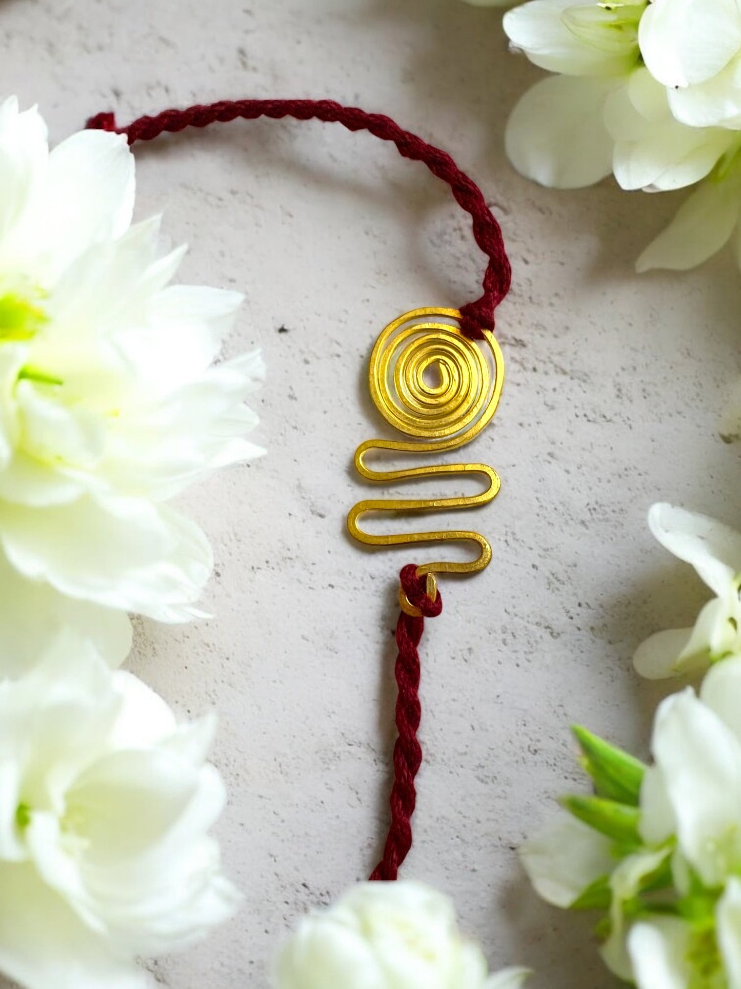 Spiral Wave Forever Brass Rakhi- Maroon