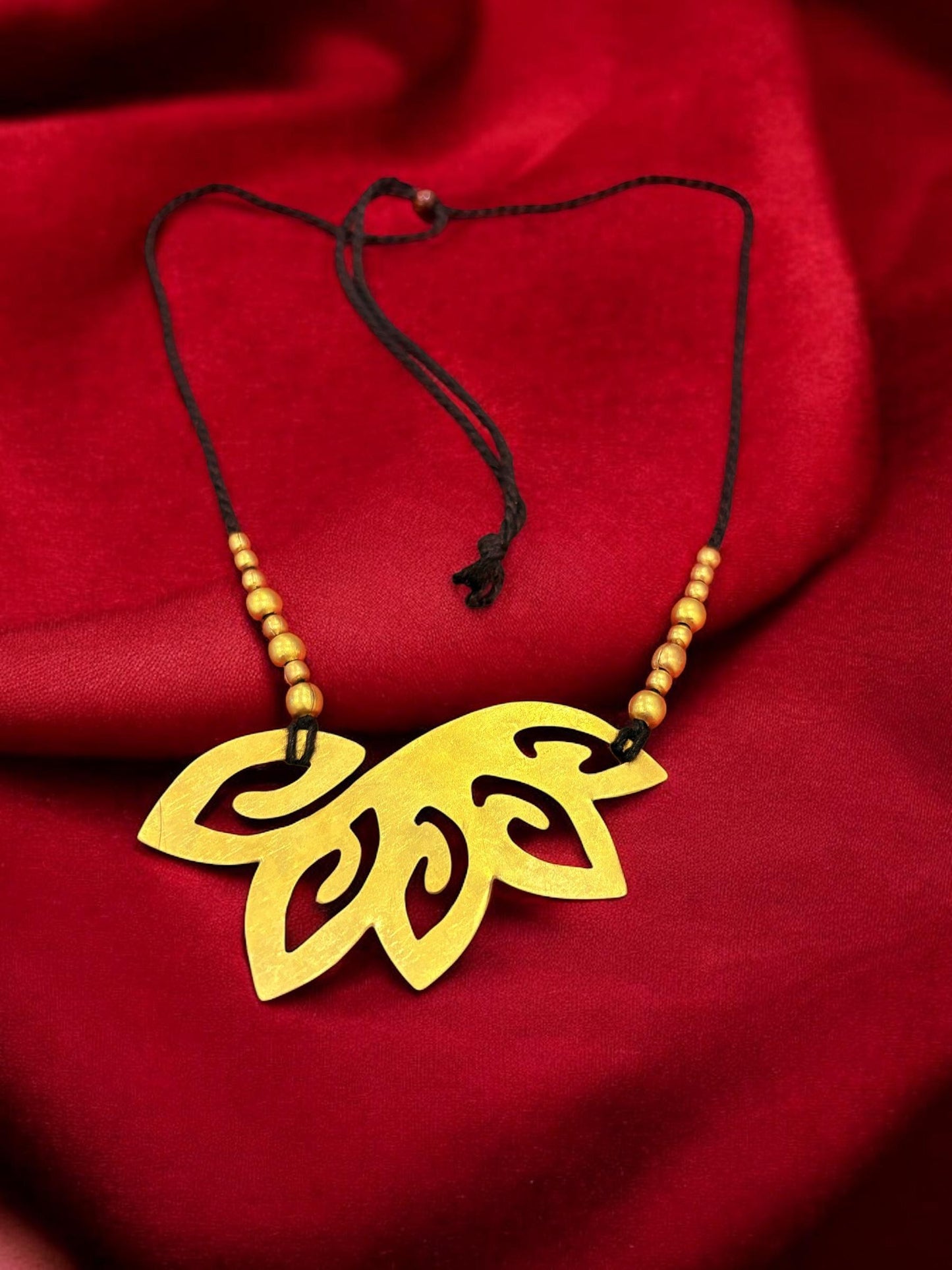 floral-cutout-brass-black-tassel-necklace